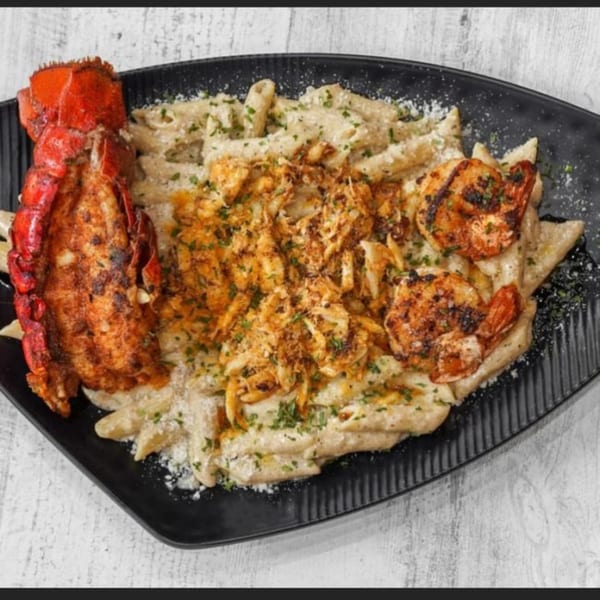 TNT Rooftop Restaurant's pasta dish with lobster tail, grilled shrimp, and crab meat.